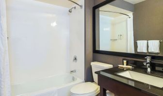 Guesth bathroom with tub and shower at Comfort Inn Kingston HWY 401.
