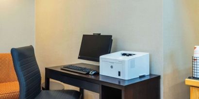 Business center with computer, printer and ergonomic chair at Comfort Inn Kingston HWY 401.