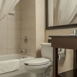 Guest bathroom with tub and free toiletries at Comfort Inn Edmundston.