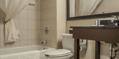 Guest bathroom with tub and free toiletries at Comfort Inn Edmundston.