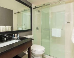 Guest bathroom with shower and free toiletries at Comfort Inn Hamilton.