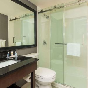 Guest bathroom with shower and free toiletries at Comfort Inn Hamilton.