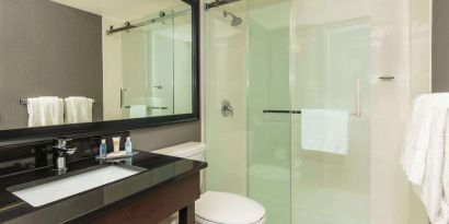 Guest bathroom with shower and free toiletries at Comfort Inn Hamilton.