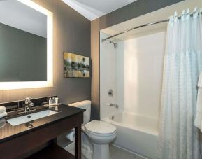 Private guest bathroom with shower and tub at Comfort Inn Dryden.