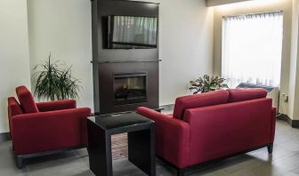 Lobby lounge with fireplace at Comfort Inn Boucherville.