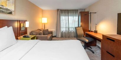 Day use room with work desk and sofa at Comfort Inn Boucherville.