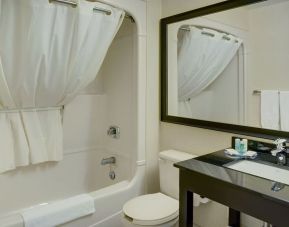 Guest bathroom with tub and free toiletries at Comfort Inn Baie Comeau.