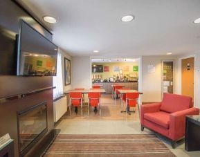 Lobby lounge with fireplace at Comfort Inn Amherst.