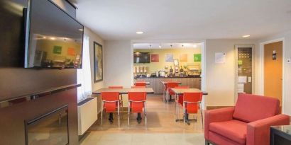 Lobby lounge with fireplace at Comfort Inn Amherst.