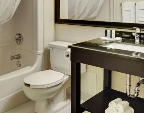 Guest bathroom with tub and free toiletries at Comfort Inn Brantford.
