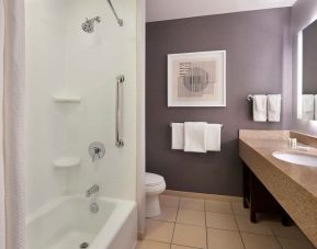 Guest bathroom with combined shower and tub at Courtyard By Marriott Waterloo St. Jacobs.