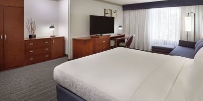 Bright and spacious day use room with TV, work desk, sofa and private bathroom at Courtyard By Marriott Waterloo St. Jacobs.