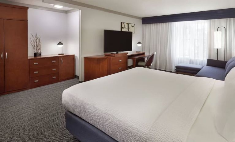 Bright and spacious day use room with TV, work desk, sofa and private bathroom at Courtyard By Marriott Waterloo St. Jacobs.