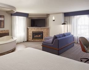 Day use suite with work desk, hot tub and living area with fireplace at Courtyard By Marriott Waterloo St. Jacobs.