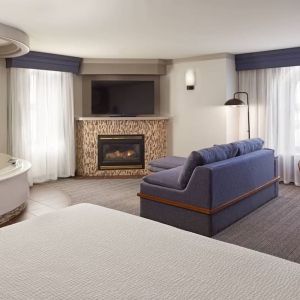 Day use suite with work desk, hot tub and living area with fireplace at Courtyard By Marriott Waterloo St. Jacobs.