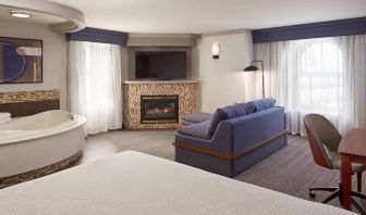 Day use suite with work desk, hot tub and living area with fireplace at Courtyard By Marriott Waterloo St. Jacobs.