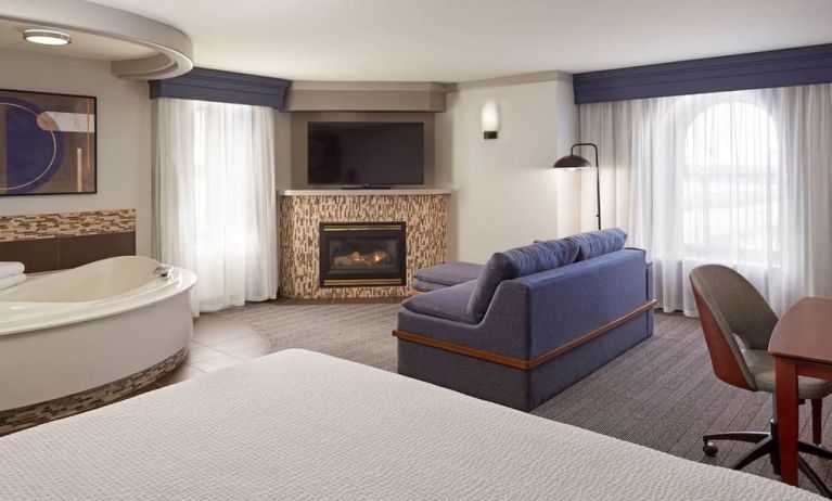 Day use suite with work desk, hot tub and living area with fireplace at Courtyard By Marriott Waterloo St. Jacobs.