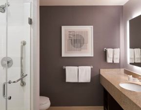 Guest bathroom with shower and free toiletries at Courtyard By Marriott Waterloo St. Jacobs.