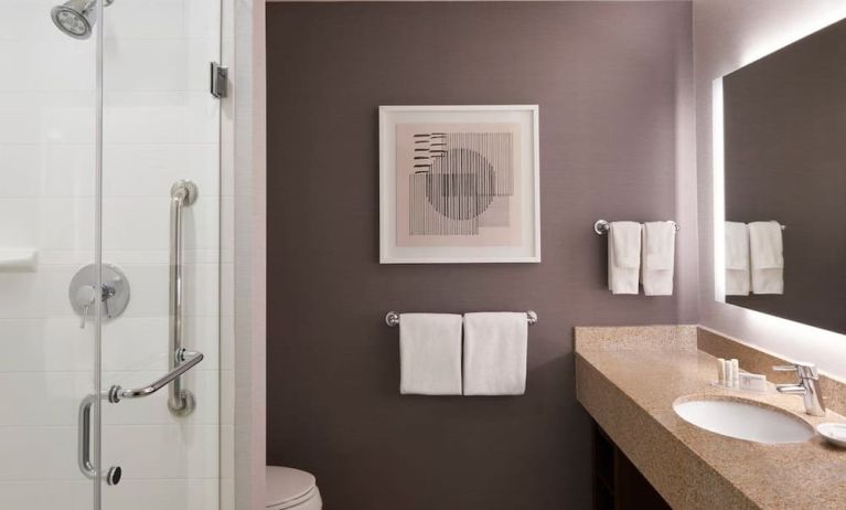 Guest bathroom with shower and free toiletries at Courtyard By Marriott Waterloo St. Jacobs.