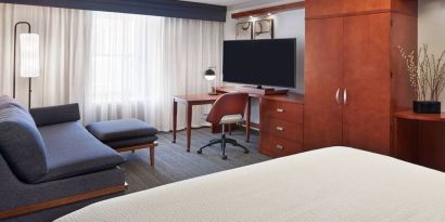 Bright and spacious day use room with TV, work desk, sofa and private bathroom at Courtyard By Marriott Waterloo St. Jacobs.