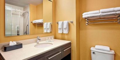 Guest bathroom with shower and free toiletries at TownePlace Suites By Marriott London.