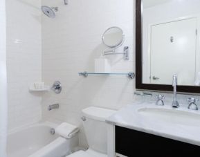 Guest bathroom with shower and tub at Arc The Hotel Ottawa.