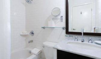 Guest bathroom with shower and tub at Arc The Hotel Ottawa.