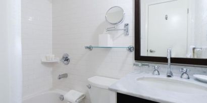 Guest bathroom with shower and tub at Arc The Hotel Ottawa.