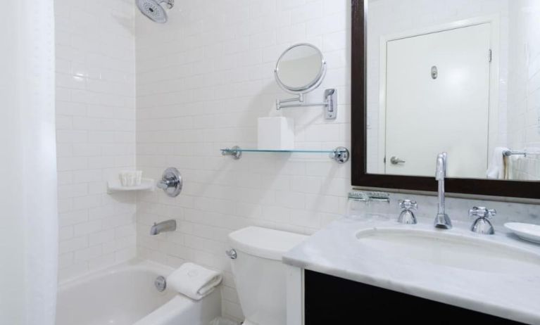 Guest bathroom with shower and tub at Arc The Hotel Ottawa.