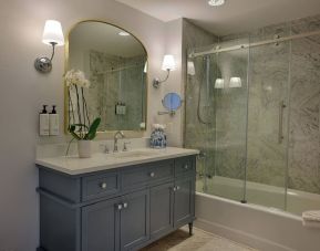 Guest bathroom with shower and tub at St James Hotel, An Ascend Hotel Collection Member.