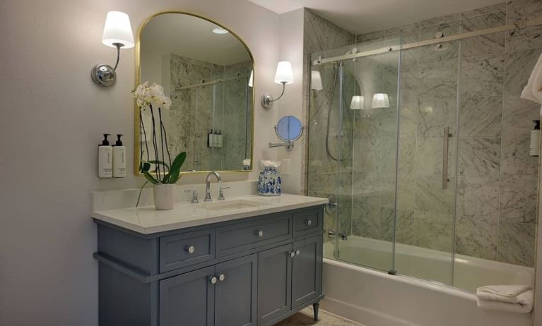 Guest bathroom with shower and tub at St James Hotel, An Ascend Hotel Collection Member.