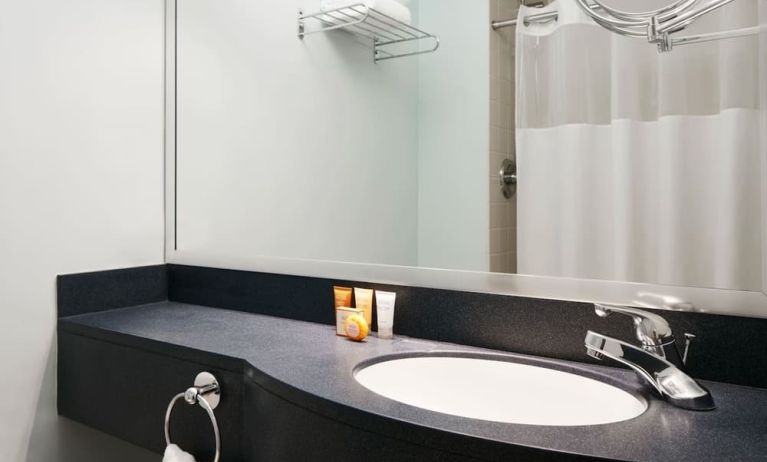 Guest bathroom with shower at Club Quarters Hotel Wacker At Michigan.