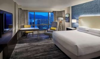 Day use room with TV, work desk and sofa at Hyatt Regency Vancouver.