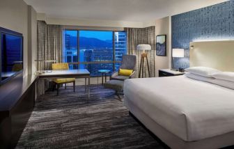 Day use room with TV, work desk and sofa at Hyatt Regency Vancouver.