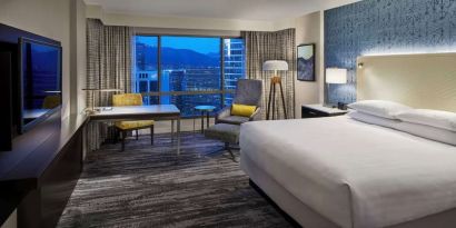 Day use room with TV, work desk and sofa at Hyatt Regency Vancouver.