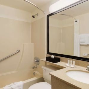 Guest bathroom with tub and free toiletries at Travelodge Edmonton South.