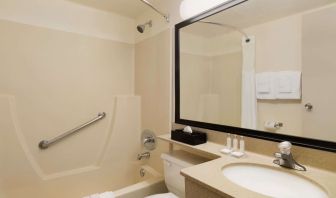 Guest bathroom with tub and free toiletries at Travelodge Edmonton South.