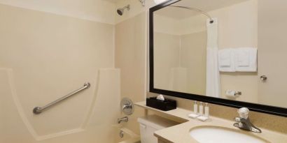 Guest bathroom with tub and free toiletries at Travelodge Edmonton South.