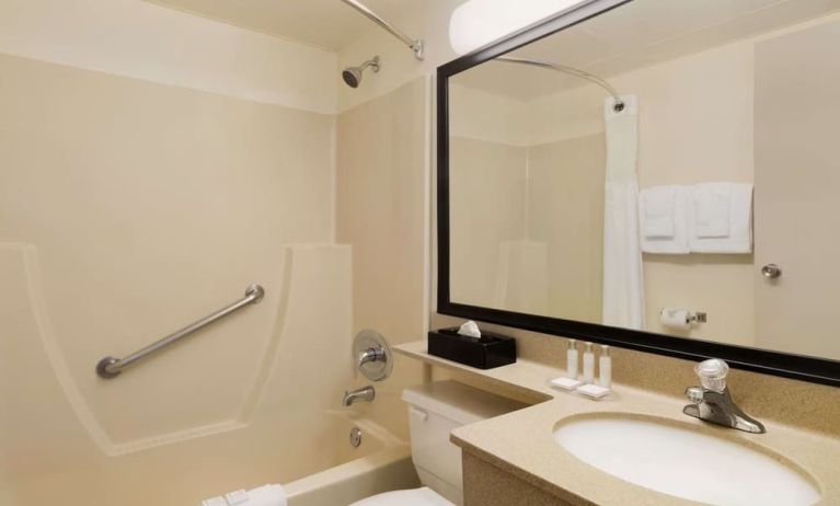 Guest bathroom with tub and free toiletries at Travelodge Edmonton South.