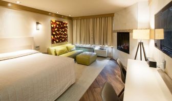 Day use room with TV, work desk, fireplace and private bathroom at Le Chabrol Hotel Et Suites.