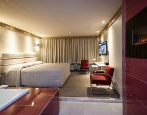 Junior suite with work desk, fireplace and hot tub at Le Chabrol Hotel Et Suites.