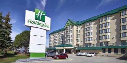 Hotel exterior and parking area at Holiday Inn Conference Center Edmonton South.