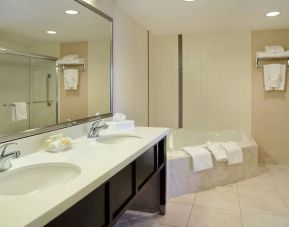 Guest bathroom with shower and hot tub at Holiday Inn Conference Center Edmonton South.