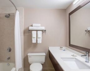 Guest bathroom with shower and tub at Delta St. John's Hotel & Conference Center.