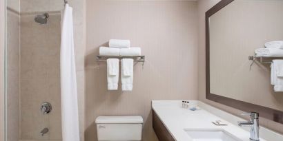 Guest bathroom with shower and tub at Delta St. John's Hotel & Conference Center.