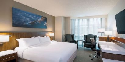 Day use room with TV, work desk and sofas at Delta St. John's Hotel & Conference Center.