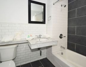 Guest bathroom with shower and tub at Bogart Hotel.