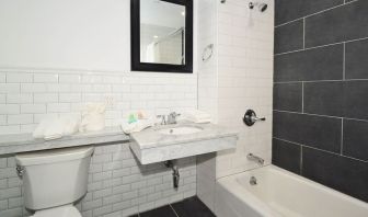 Guest bathroom with shower and tub at Bogart Hotel.