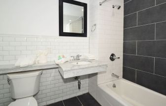 Guest bathroom with shower and tub at Bogart Hotel.