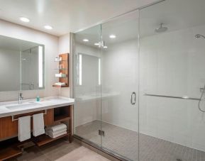 Guest bathroom with shower and free toiletries at Delta Hotel By Marriott Regina.